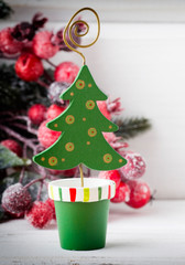 Christmas decoration with fir branches on the wood background.