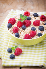 Oatmeal porridge with berries. Raspberries and blueberries.