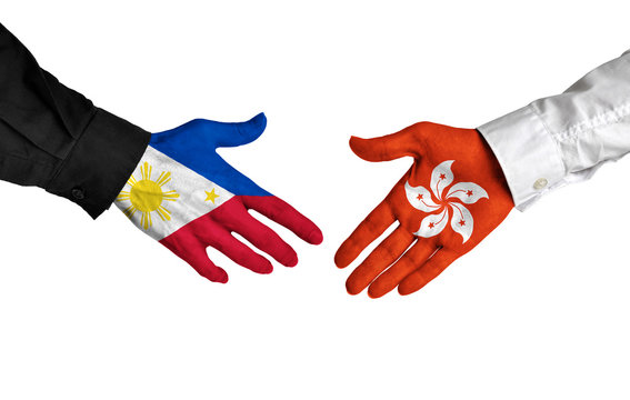Philippines and Hong Kong leaders shaking hands on a deal agreement