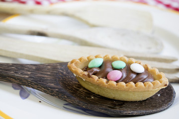 Obraz na płótnie Canvas chocolate pastry with colored sugared almonds