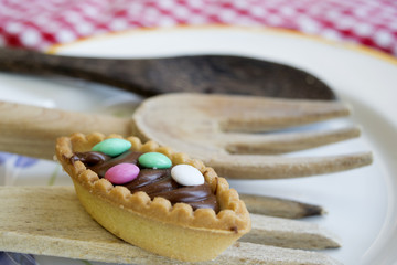 chocolate pastry with colored sugared almonds