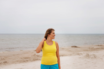 Tired woman standing on the beach