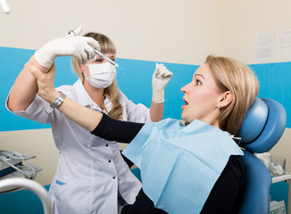 Doctor examines the oral cavity on tooth decay. Caries protection. Tooth decay treatment. Doctor...