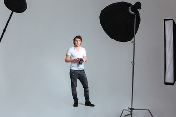 Photographer standing in professional studio © Drobot Dean