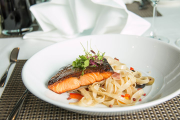  pasta with salmon on white  plate