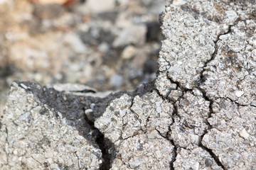 Macro closeup on concrete asphalt cracks on the road.