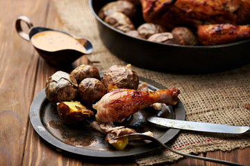 Barbecued chicken leg with baked potatoes