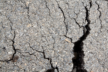 Macro closeup on concrete asphalt cracks on the road.