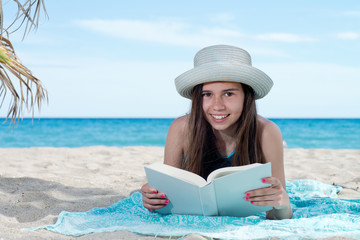 girl on the beach with book