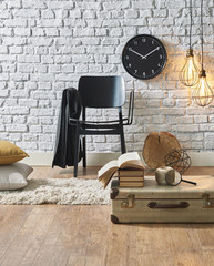 white brick wall interior black clock and suitcase