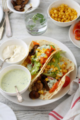 two tacos with sauce on plate