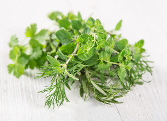 Fresh herbs on wooden background