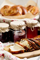 Fruit and berry jam in jars. Different kinds of buns.