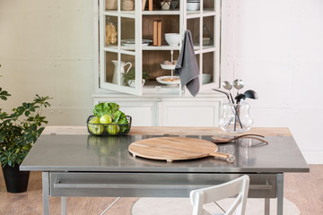 empty cutting board behind kitchen cupboard with metal kitchen countertop modern kitchen