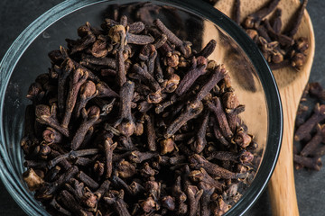 Glass Bowl of Cloves with Wooden Spoon Off to the Side