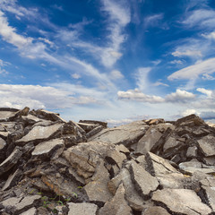 .Fragments of broken asphalt road and sky.