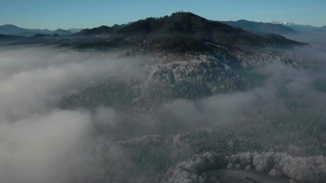 First person view above clouds, fog, mist on frozen forest landscape. At the end is simulated helicopter, multicopter stall,  crash.
