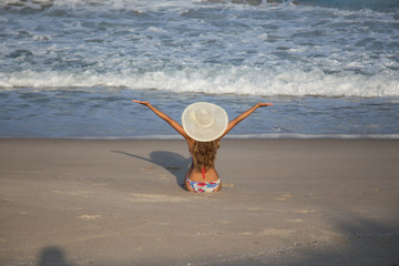 girl in hat on the beach sea bikini