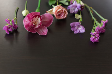 flowers pink  on a dark wooden background