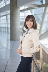 Fototapeta na wymiar Attractive asian business woman smiling outside office