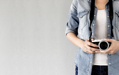 hipster traveler photographer girl taking picture on vintage camera, traveling holiday photography concept, retro color tone, nature light [blur and select focus background]