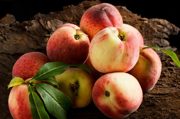 Peaches over wooden background