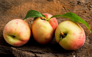 Peaches over wooden background