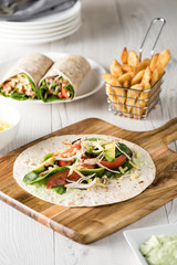 shredded barbecued chicken wraps with carrot, cheese, avocado an