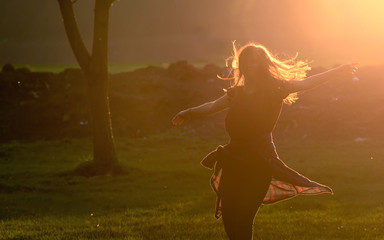 Teen girl jump against beautiful sunset