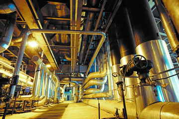 Equipment, cables and piping as found inside of a modern industr