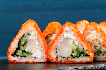 Tasty fusion rolls with orange tobiko roe, cream cheese