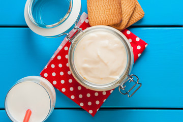 Homemade yogurt on a blue wooden table.