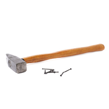 Big hammer with pile of nails over white isolated background