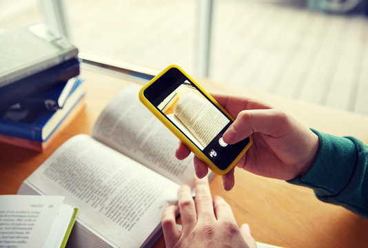 Student Hands With Smartphone Making Cheat Sheet