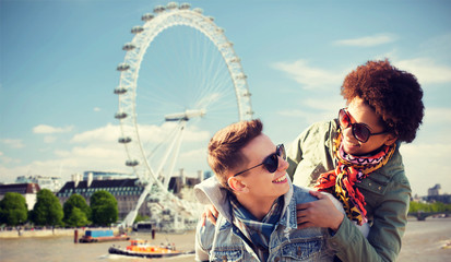 happy teenage couple having fun over london