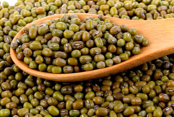 Green mung beans in spoon on white background