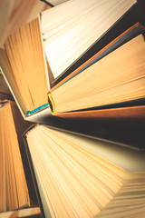 Old and used hardback books or text books seen from above.