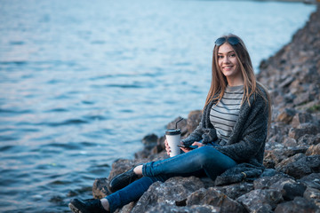 girl walking with coffee and phone