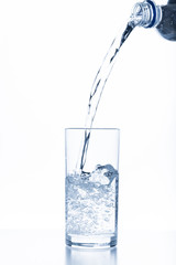 water pouring in glass isolated on white background