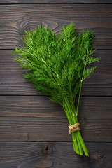 bunch of dill on wooden background