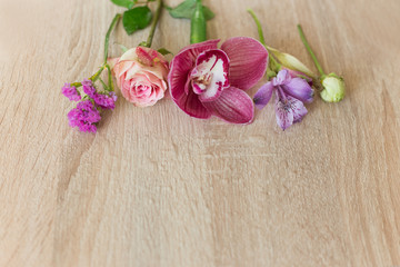 flowers pink water drops on a light wooden background
