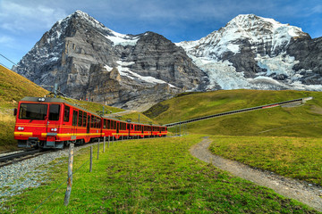 Fototapeta na wymiar Electric tourist train and Eiger North face,Bernese Oberland,Switzerland