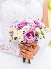 Wedding flowers ,Woman holding colorful bouquet with her hands on wedding day