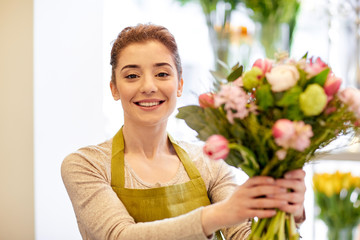 smiling florist woman making bunch at flower shop