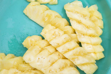 Slice pineapple on green tray copyspace.
