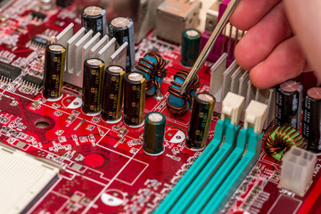 technician's hand assembling personal computer