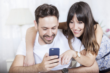 A picture of a young couple using a phone