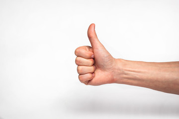 male hand showing thumbs up sign 