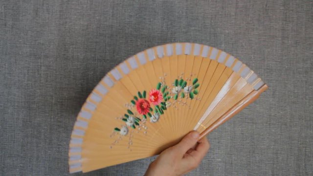 female hand with a folding fan