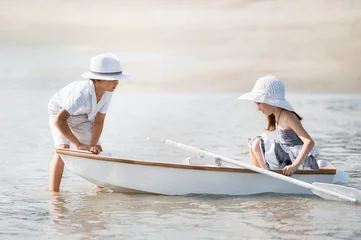 Foto op Canvas Boy with a girl riding on a boat © Alexandr Vasilyev